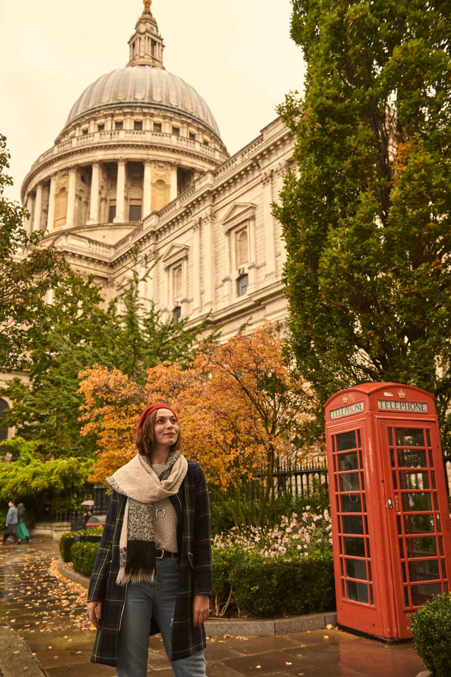 Woman standing in the gardens in front of St Paul's Cathedral, City of London