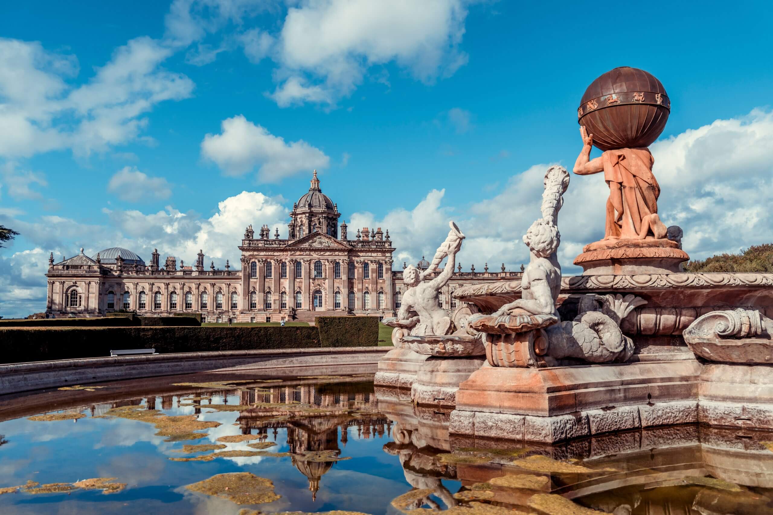 A view to Castle Howard from across the Atlas Fountain in the gardens at Castle Howard