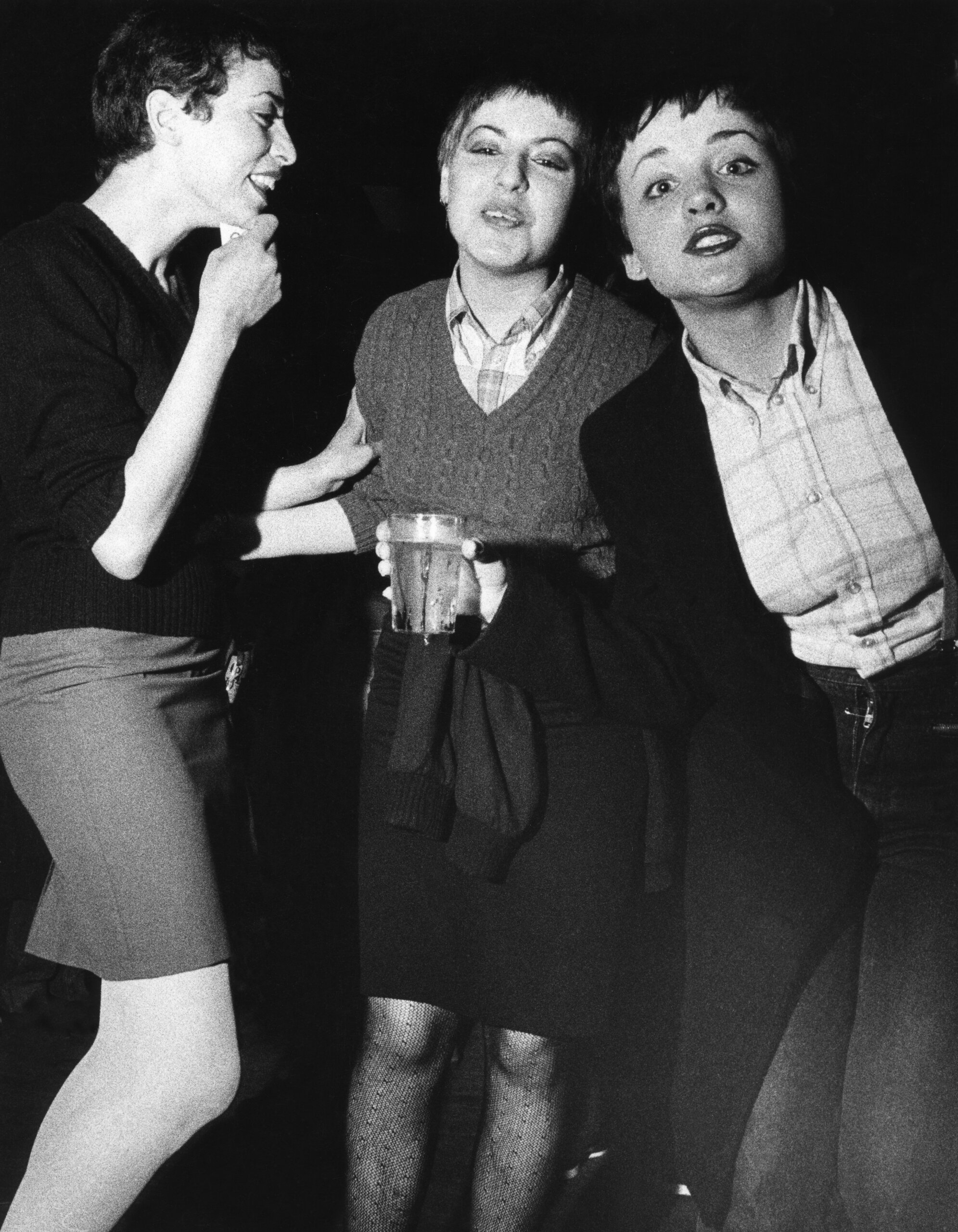 Three skinhead / mod girls, women, laughing and drinking, UK, 1980's