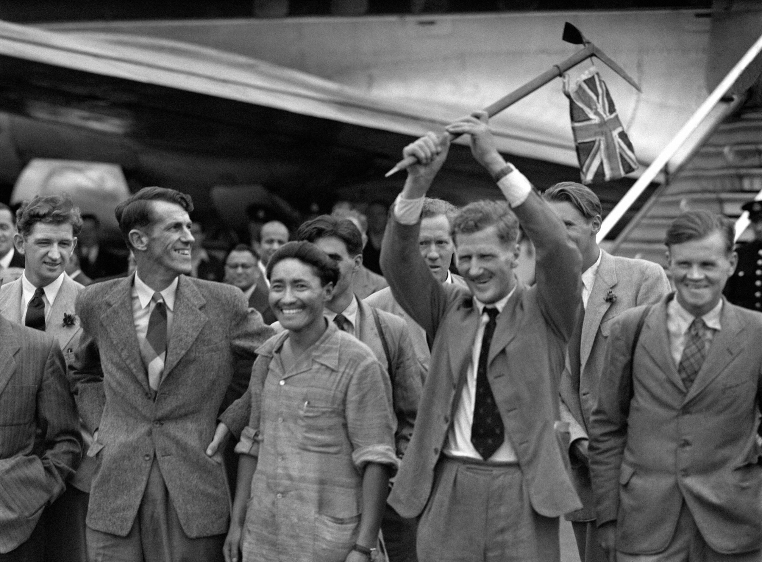 Edmund Hillary of New Zealand and the Sherpa Tensing Norgay stepped from a BOAC airliner at Heathrow Airport in London, to receive a huge welcome whilst Colonel John Hunt waves a flag after their successful climb of the Everest mountain. // These 25 pictures showcase some of Heathrow's most iconic moments as it celebrates its 80th birthday. Officially opened as ‘London Airport’ in 1946 following two years of construction, its first flight in the newly post-war era was a converted Lancaster bomber called Starlight that flew to Buenos Aires. In its first year, 63,000 passengers had taken to the skies, compared to the 67 million who now jet off annually. The busiest airport in Europe, renamed Heathrow in September 1966, has seen many iconic moments in its 80 years of operation, from The Beatles’ return home from a US tour to England Rugby bringing home the World Cup. This photo licensed for one time use only in connection with SWNS story on the 80th anniversary of Heathrow Airport, no re-use, no archive.