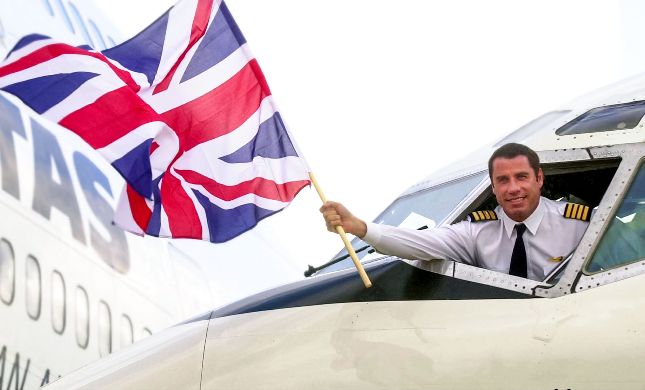 Hollywood actor John Travolta waves a flag from the cockpit of the plane which he had landed at Heathrow airport earlier. // These 25 pictures showcase some of Heathrow's most iconic moments as it celebrates its 80th birthday. Officially opened as London Airport in 1946 following two years of construction, its first flight in the newly post-war era was a converted Lancaster bomber called Starlight that flew to Buenos Aires. In its first year, 63,000 passengers had taken to the skies, compared to the 67 million who now jet off annually. The busiest airport in Europe, renamed Heathrow in September 1966, has seen many iconic moments in its 80 years of operation, from The Beatles return home from a US tour to England Rugby bringing home the World Cup.