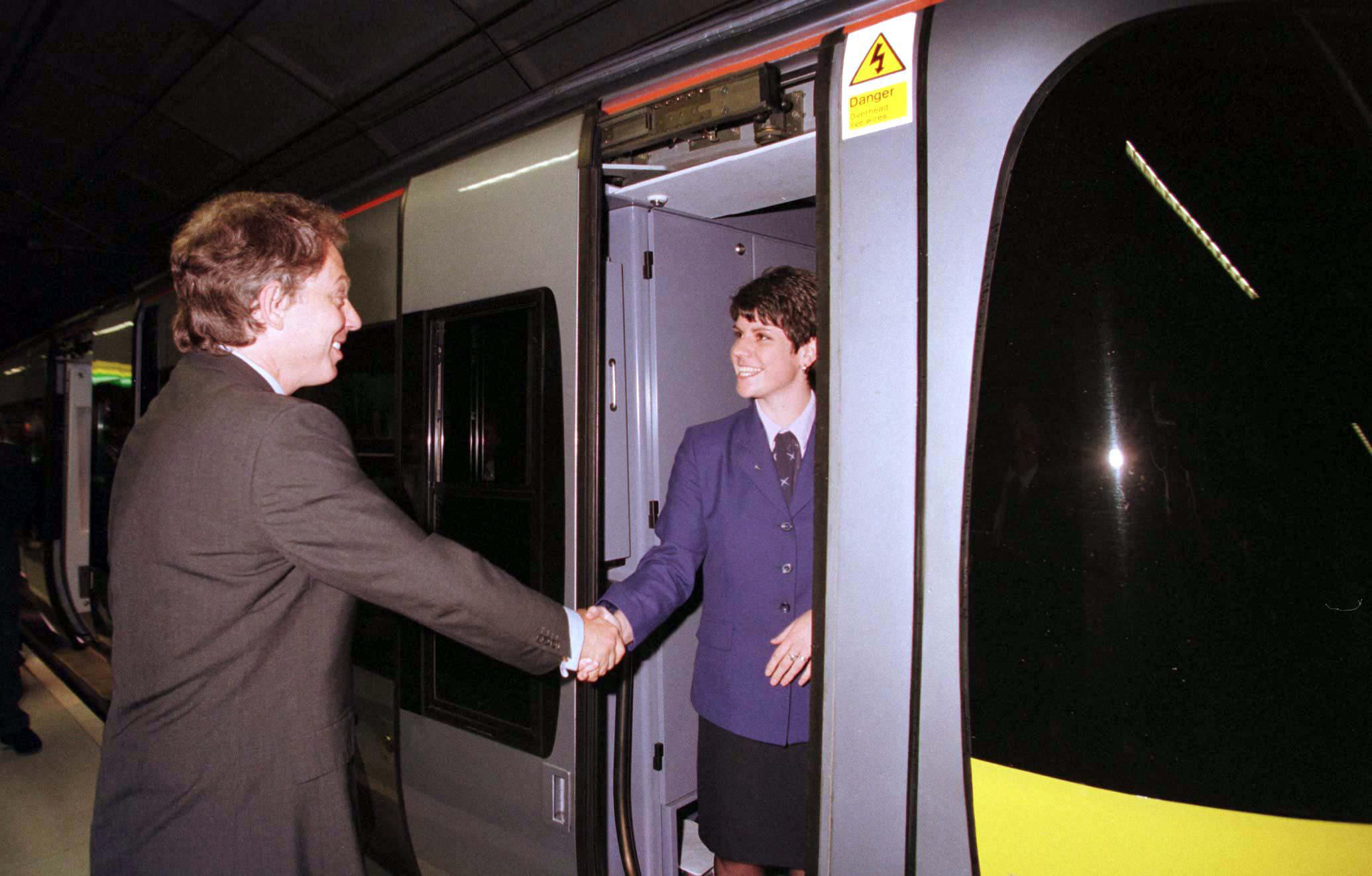 Prime Minister Tony Blair speaks to Claire Pick, the driver of the Heathrow Express train which he travelled on this morning (Tuesday) when he officially opened 450 million Heathrow Express rail link. // These 25 pictures showcase some of Heathrow's most iconic moments as it celebrates its 80th birthday. Officially opened as London Airport in 1946 following two years of construction, its first flight in the newly post-war era was a converted Lancaster bomber called Starlight that flew to Buenos Aires. In its first year, 63,000 passengers had taken to the skies, compared to the 67 million who now jet off annually. The busiest airport in Europe, renamed Heathrow in September 1966, has seen many iconic moments in its 80 years of operation, from The Beatles return home from a US tour to England Rugby bringing home the World Cup. This photo licensed for one time use only in connection with SWNS story on the 80th anniversary of Heathrow Airport, no re-use, no archive.