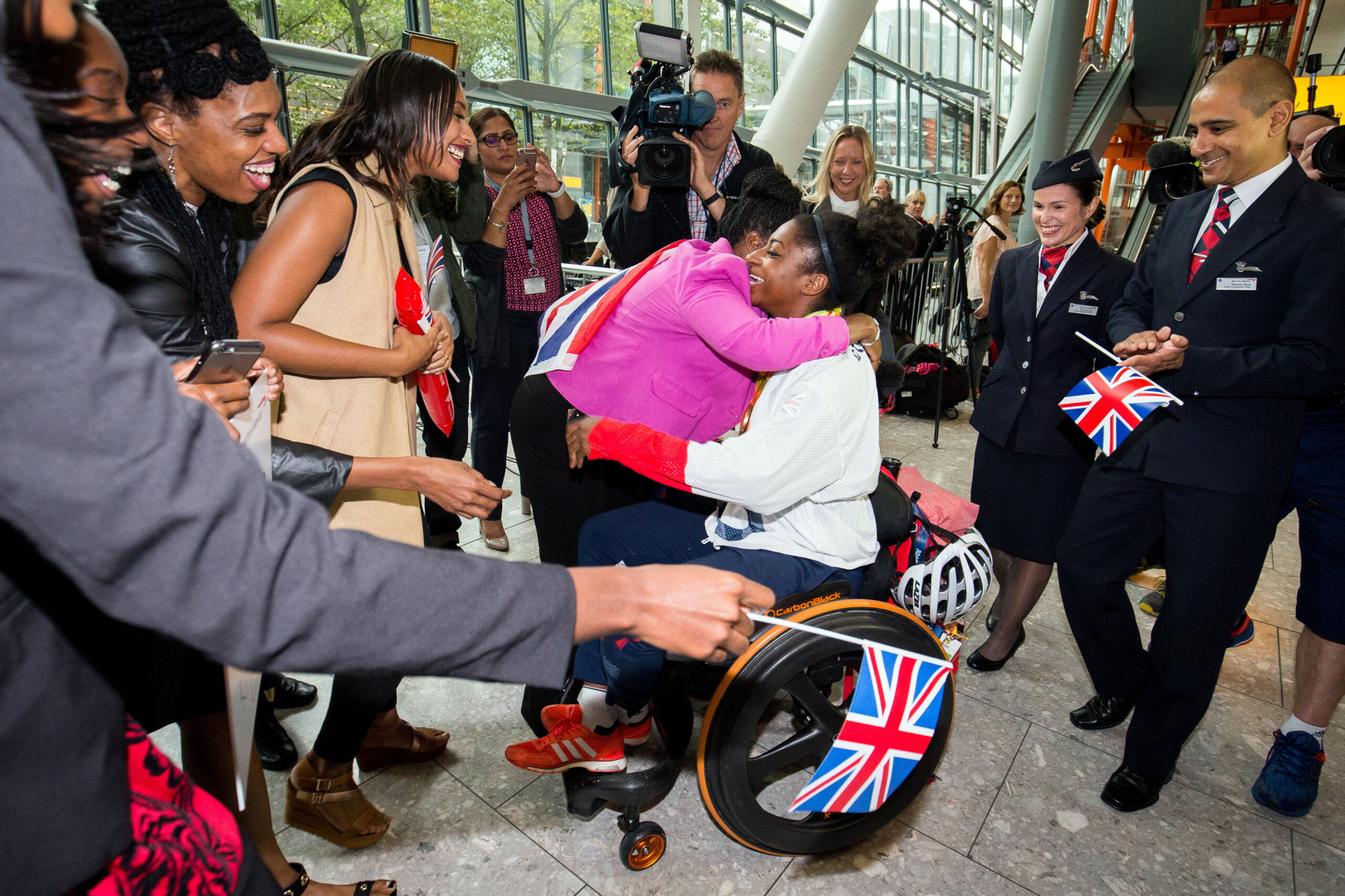 Kadeena Cox is greeted by family as Great Britain's Paralympic team returns from the Rio Paralympics to Heathrow Airport, London. 20 September 2016. // These 25 pictures showcase some of Heathrow's most iconic moments as it celebrates its 80th birthday. Officially opened as London Airport in 1946 following two years of construction, its first flight in the newly post-war era was a converted Lancaster bomber called Starlight that flew to Buenos Aires. In its first year, 63,000 passengers had taken to the skies, compared to the 67 million who now jet off annually. The busiest airport in Europe, renamed Heathrow in September 1966, has seen many iconic moments in its 80 years of operation, from The Beatles return home from a US tour to England Rugby bringing home the World Cup.