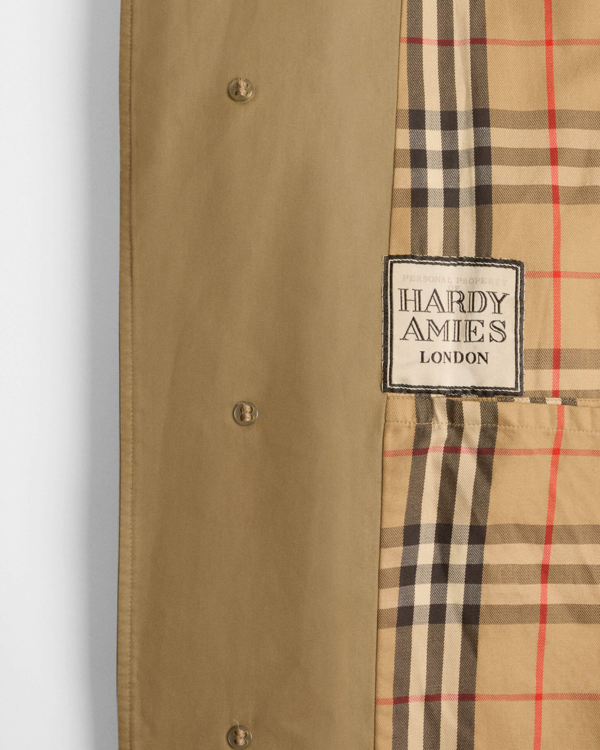Detail of the personalised label in British fashion designer Hardy Amies’s Burberry car coat_ 1979